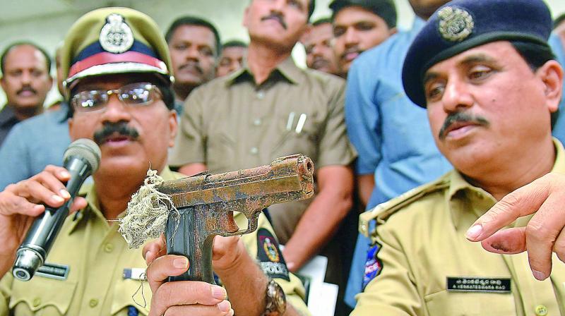 Hyderabad Commissioner of Police M. Mahender Reddy displays to the media the country-made pistol which was used in the shooting of Vikram Goud recently. The cops also seized cash worth Rs 5.3 lakh, one vehicle and  eight mobile phones. 	(Photo:DC)
