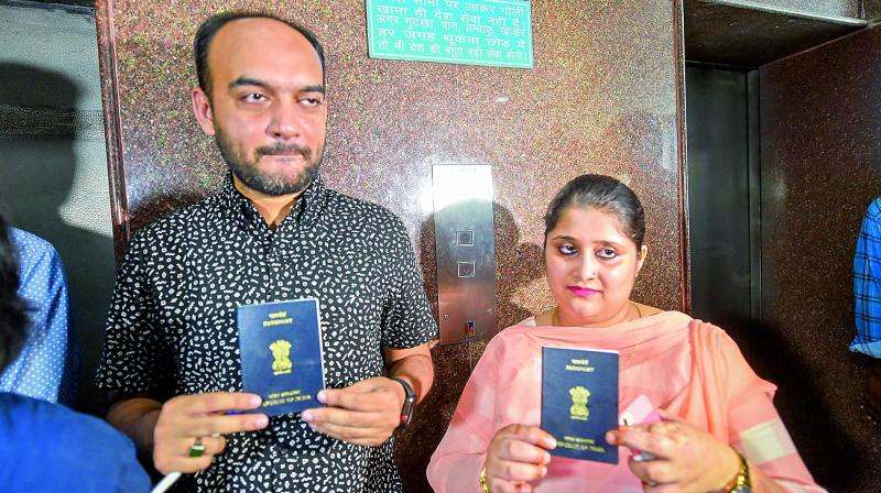Mohammad Anas Siddiqui and Tanvi Seth show their passports issued to them by the Regional Passport Office, in Lucknow on Thursday. (Photo:  PTI)