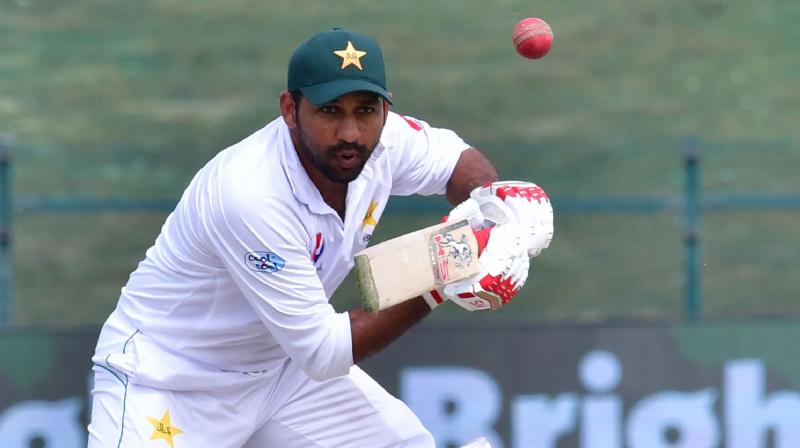 Pakistan captain Sarfraz Ahmed has been taken to hospital and did not take the field on day four of the second Test against Australia after taking a blow to the helmet, while visiting batsman Usman Khawaja was ruled out with a knee injury. (Photo: AFP)