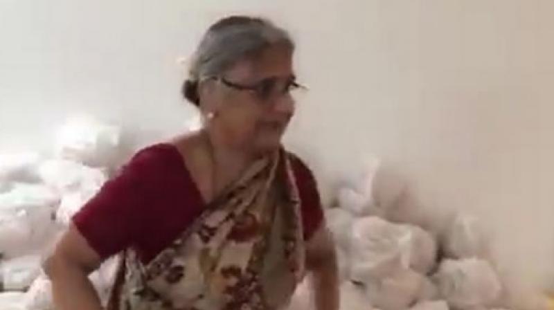 Infosys co-founder NR Narayana Murthys wife Sudha Murthy is seen supervising the relief material packed in bags embossed with Infosys. (Photo: Twitter Screengrab | @DVSBJP)