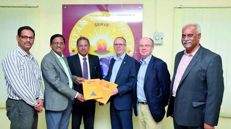 Representatives of the Gitam University and the UK-based Lancaster University exchange MoU documents in Visakhapatnam on Wednesday for the latter to offer collaborative academic programs at the proposed Gitam University off campus at Amaravati.