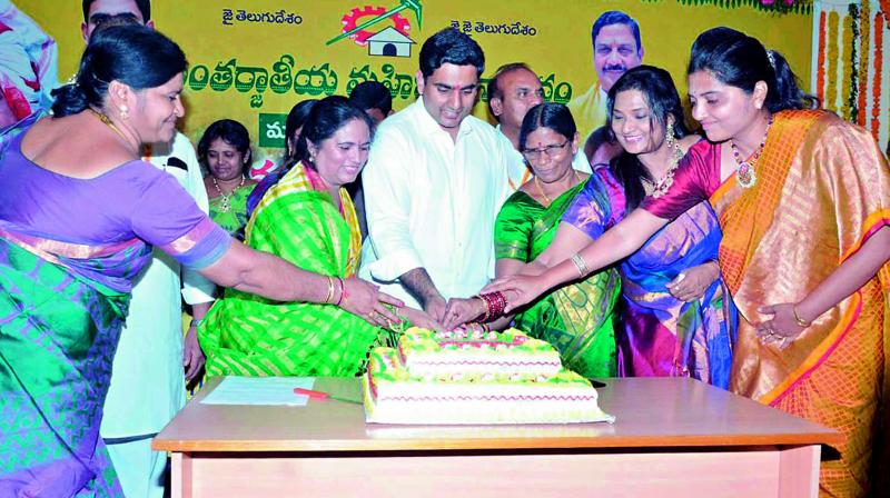 TD national secretary N. Lokesh cuts a cake with the TD women activists during the International Womens Day celebrations at TD state office in Guntur on Wednesday.
