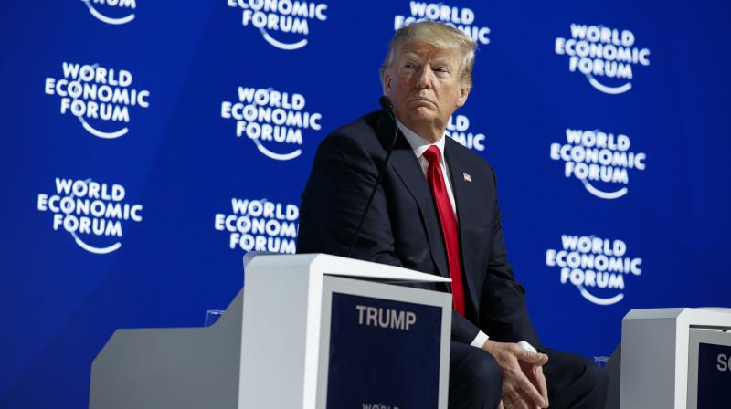 US President Donald Trump listens as he is introduced to deliver a speech to the World Economic Forum. (Photo: AP)