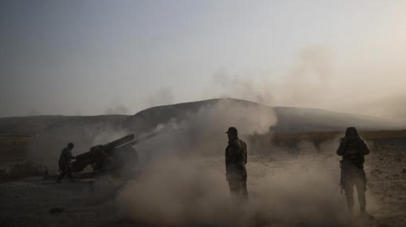 Kurdish Peshmerga soldiers fire artillery at Islamic State positions in Bashiqa, east of Mosul. (Photo: AP)