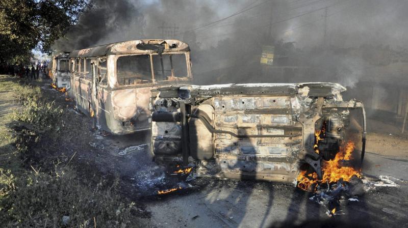 Angry people set on fire vehicles in Imphal East district on Sunday in protest against the United Naga Council (UNC)s indefinite economic blockade. (Photo: PTI)