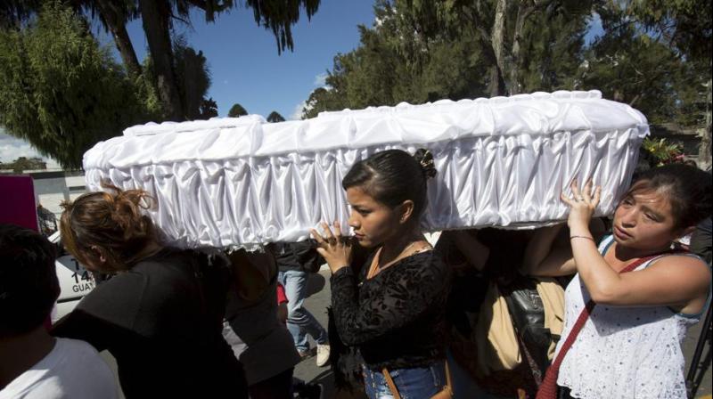 Women carry the coffin containing the remains of 17-year-old Siona Hernandez Garcia, who died in a fire at the Virgin of the Assumption Safe Home, at the Guatemala Citys cemetery.(Photo: AP)
