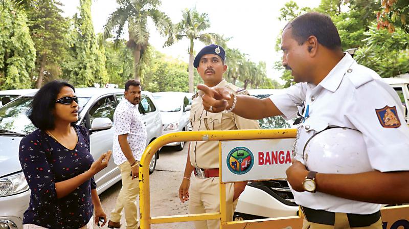 A woman, stuck in a traffic jam, argues with a police officer near Raj Bhavan on Wednesday afternoon  (Image: DC)