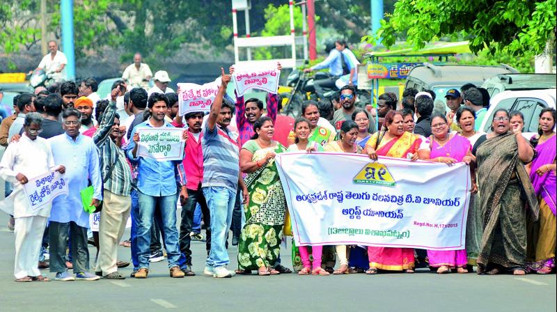 Members of junior artist association display placards in a procession in Vizag on Monday. (Photo: DC)