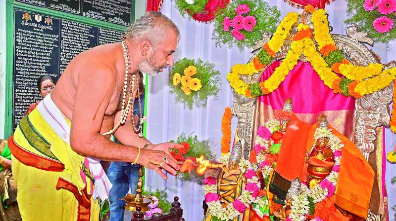 A priest offers harati to Lord Rama and Sita Devi during the Kalyana Mahotsavam held at a temple in Guntur on Monday. (Photo: DC)