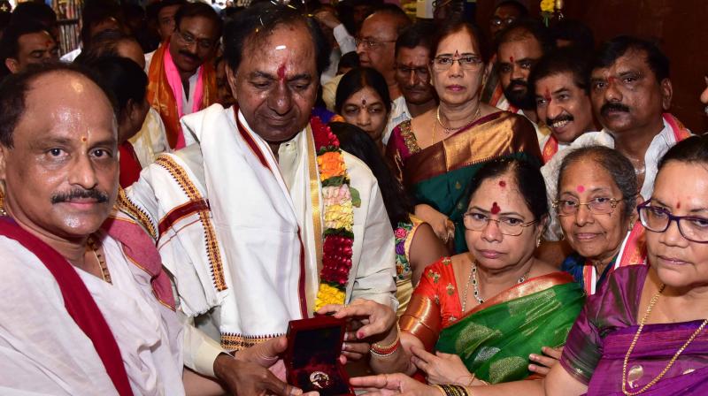 Telangana Chief Minister K. Chandrasekhar Rao along with family members present the nose ring to Goddess Durga in Vijayawada on Thursday. (Photo: DC)