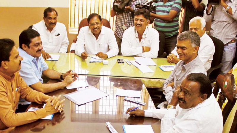 Dy CM G. Parameshwar, Ministers D.K. Shivakumar, R.V. Deshpande, Krishna Byregowda, Jayamala, Zameer Ahmed Khan, K.J. George at a meeting in Bengaluru on Thursday.