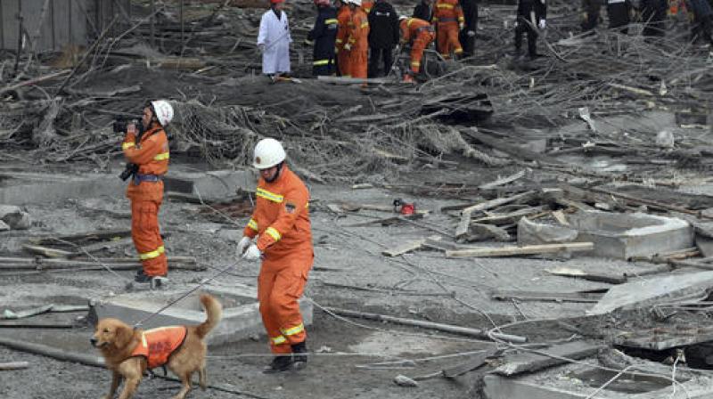 Rescue workers look for survivors after a work platform collapsed at the Fengcheng power plant in eastern China. (Photo: AP)