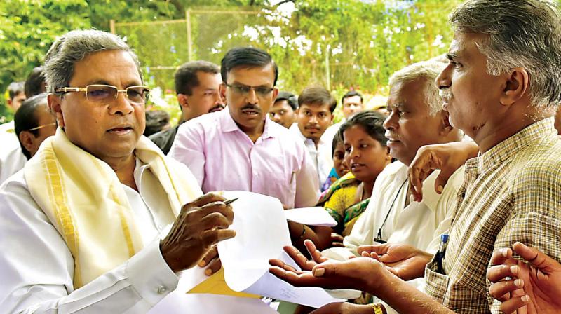 Chief Minister Siddaramaiah listens to the grievances of the public at Cauvery, his residence in Bengaluru on Wednesday.