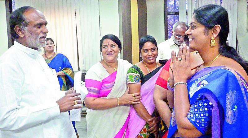 Telangana state BJP president K. Laxman felicitates women who joined the party recently, at the party office in Hyderabad on Wednesday. (Photo: DC)
