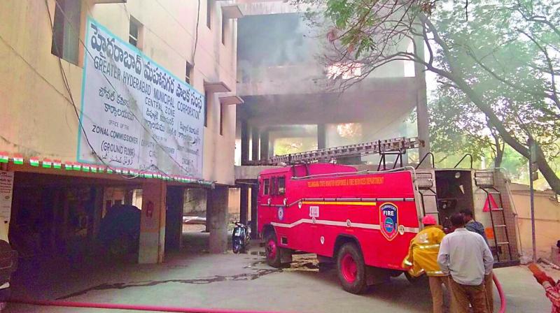 Fire officials try to douse the fire that broke out at the Greater Hyderabad Municipal Corporation (GHMC) central zone office at Khairatabad. (Photo: DC)