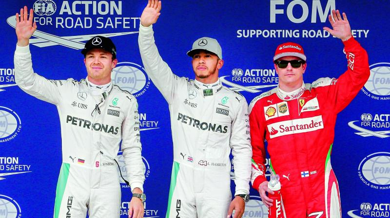 Mercedes Lewis Hamilton (centre) celebrates after grabbing pole ahead of Nico Rosberg (left) and Ferraris Kimi Raikkonen during the qualifying session in Sao Paulo (Photo: AFP)