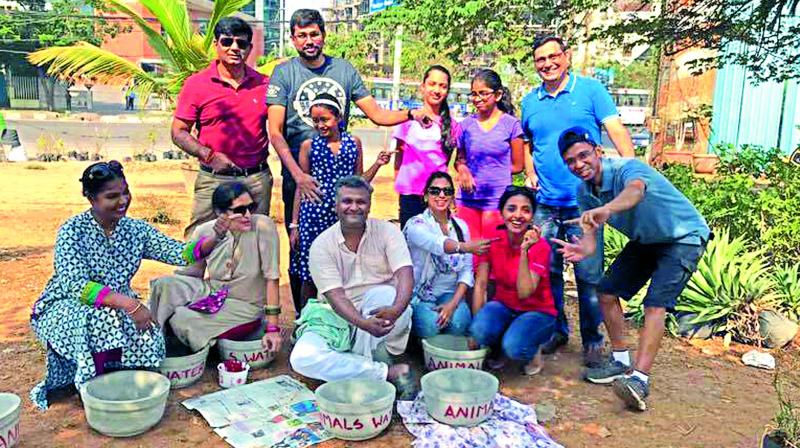 Lakshman (far right)  and his team of volunteers  pose with the bowls that they plan to distribute