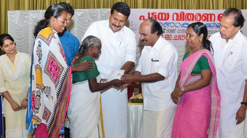 Revenue minister E. Chandrasekharan distributes title deeds to beneficiaries in Kakkanad on Friday.