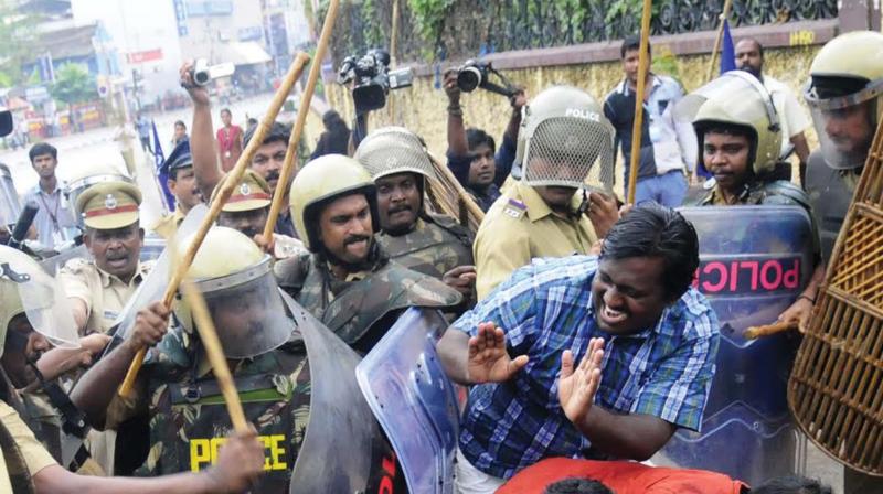 Police personnel round up and beat an agitator during a protest in front of the secretariat in Thiruvananthapuram. (File pic)