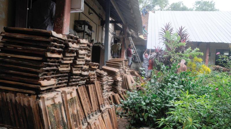 The roof tiles of century-old Freemasons club building inside the Directorate of Public Instruction (DPI) being pulled out.  (Photo: DC)