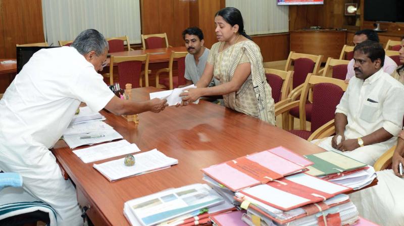 Jishnu Pranoys mother Mahija hands out a memorandum to Chief Minister Pinarayi Vijayan in Thiruvananthapuram on Wednesday. 	(Photo: DC)