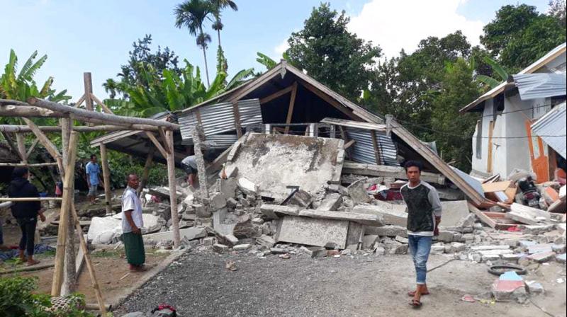 Villagers walk near destroyed homes in an area affected by the early morning earthquake at Sajang village, Sembalun, East Lombok, Indonesia, Sunday. (Photo: AP)