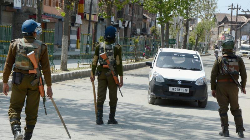 Security personnel stop a vehicle during restrictions imposed to maintain law and order in Srinagar. (Photo: PTI)