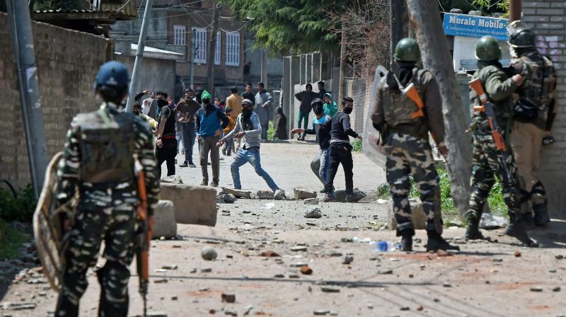 Youths throw stones on Security forces during clashes in Srinagar on Sunday. (Photo: PTI)