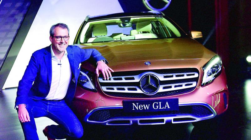 Luxury carmaker Mercedes-Benz India strengthened it SUV portfolio by launching a new variant of its volume grosser GLA Class. Vice-president sales and marketing Michael Jopp is seen with newly launched GLA in Mumbai on Wednesday. (Photo: AP)