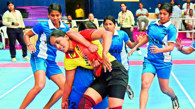 Kerala women players trap Andhra raider (centre) in their pre-quarterfinal of 65th Senior National Kabaddi Championship at the GMC Balayogi Stadium in Gachibowli, Hyderabad. Kerala won 31-21.