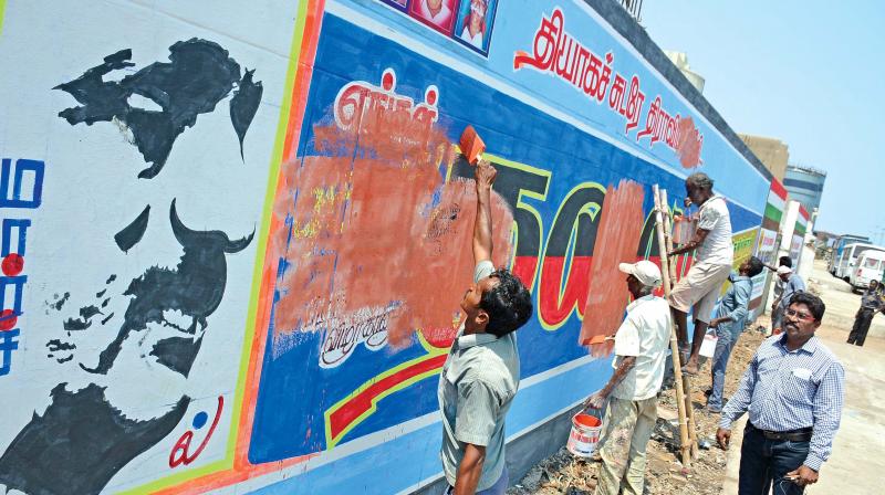 Corporation workers remove political posters and graffiti on walls in RK Nagar  assembly constituency on Friday. (Photo: DC)
