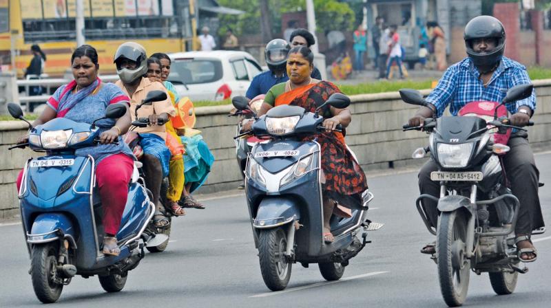 Bikers continue riding without helmet on Kamarajar Salai throwing norms to  the winds. 	Image: DC