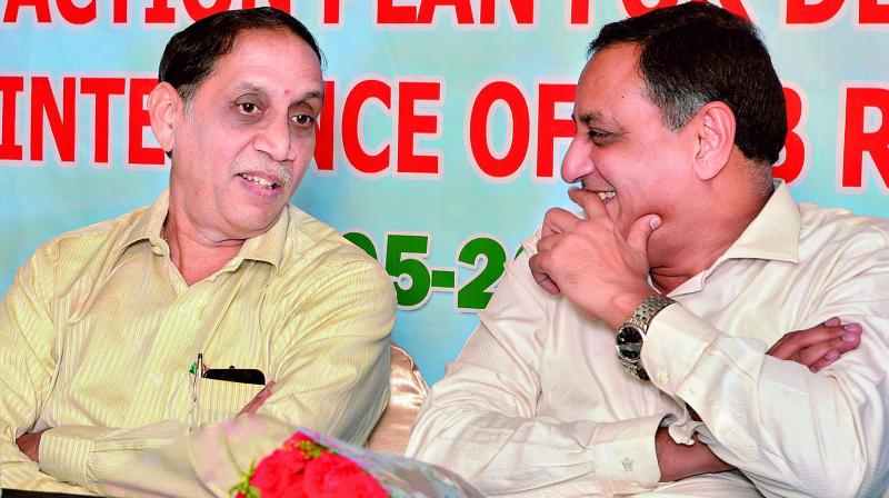 National Highways engineer-in-chief E. Subbaraya Sharma(left) shares a word with engineer-in-cief (R&B) G. Jagannatha Rao at a workshop in Vijayawada.