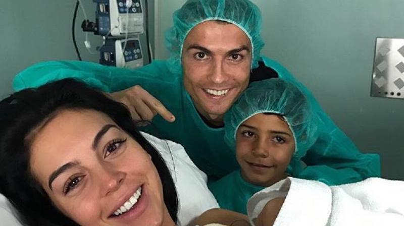 Cristiano Ronaldo posted a photo Sunday on Twitter of him with the baby Alana Martinas mother, Georgina Rodriguez, and his oldest son in a hospital in Madrid. (Photo: Twitter)