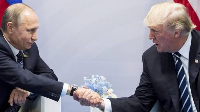 US President Donald Trump, right, and Russian President Vladimir Putin shake hands during the G20 summit in Hamburg, Germany (Photo: AP/ PTI)