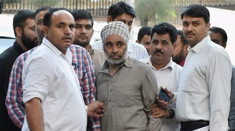 Khalistan Liberation Force chief Harminder Singh Mintoo comes out after being produced at Patiala House Court in New Delhi on Monday. (Photo: PTI)