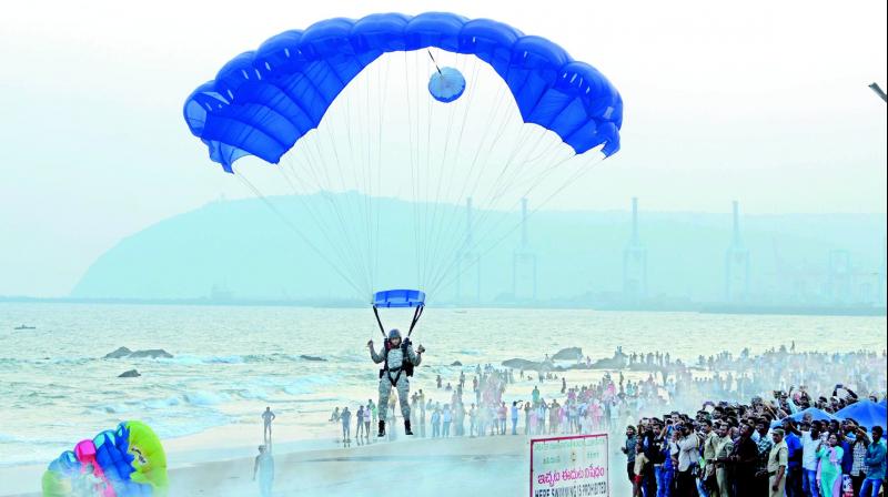 Marine commandos demonstrate how to make a safe landing from a parachute during rehearsals for the upcoming Navy Day celebrations, on Ramakrishna Beach in Visakhapatnam on Thursday. 	 (deccan chronicle)