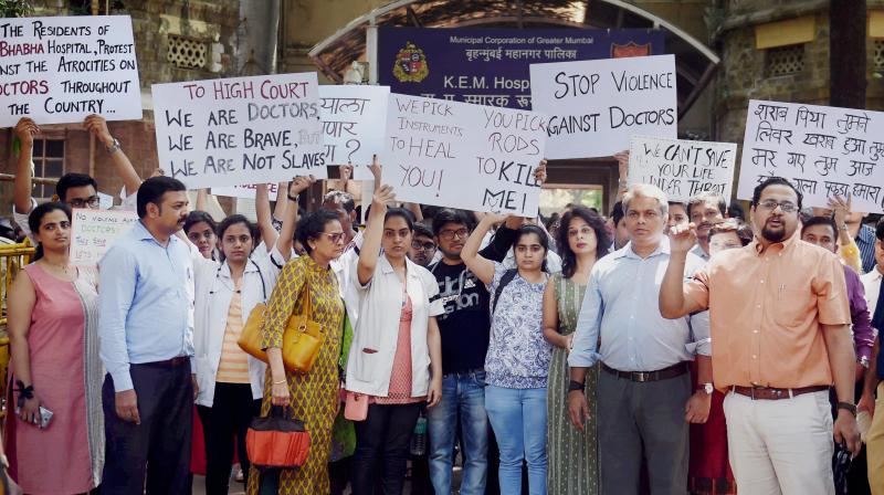 Resident doctors along with senior doctors take out a protest rally at the KEM hospital demanding security after an intern was assaulted by patients relatives, in Mumbai. (Photo: PTI)