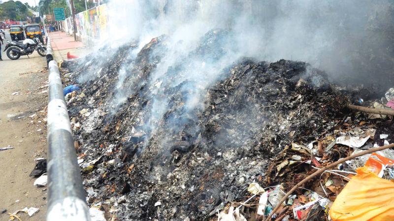 WASTED LESSON: The corporation is conducting waste management and kitchen bin lessons in Palayam. However, hardly 1 km away, the corporation scavengers are burning waste, that too in the heart of the city at Thampanoor. (Photo:  Peethambaran Payyeri)