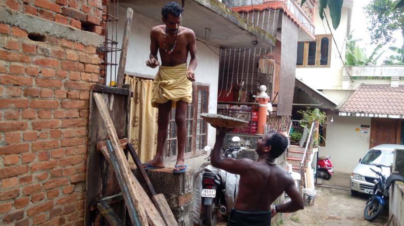 Rajesh helps brother-in-law Manikantan K. to repair the latters house at Kulappura Bund Road.