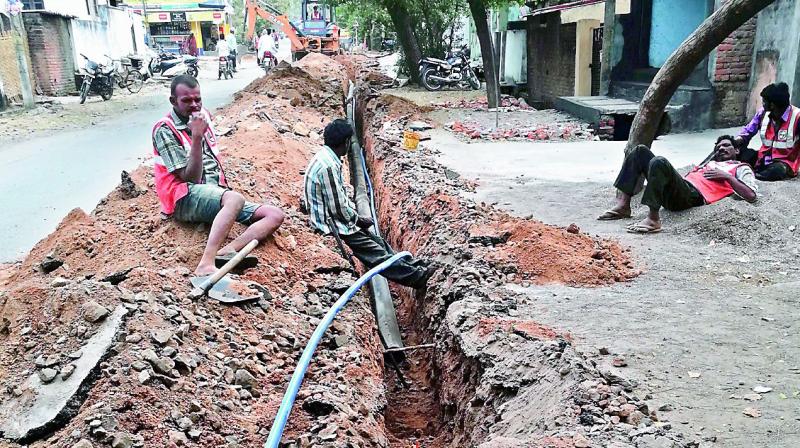 Pipes are being laid for internet cables along with the water pipes under the MB in the Adilabad town. (Photo: DC)
