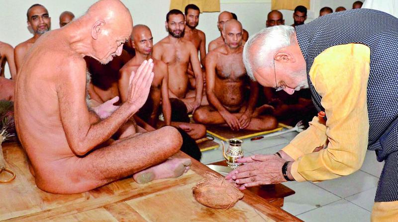 Prime Minister Narendra Modi seeks blessing of Acharya Vidyasagar Maharaj at Jain temple in Bhopal on Friday. (Photo: PTI)
