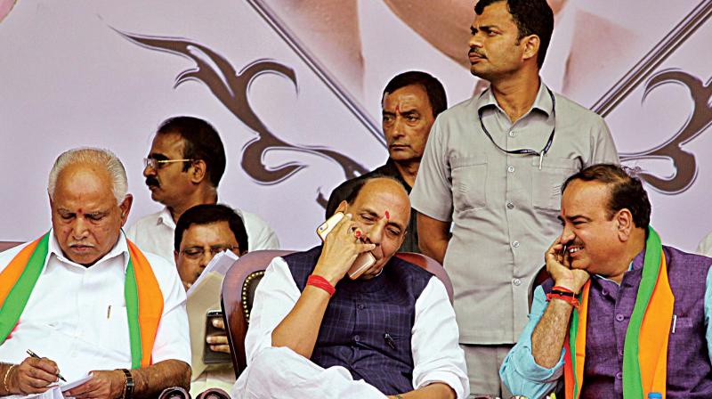 Union Home Minister Rajnath Singh, BJP state president B.S. Yeddyurappa and Union Minister Ananth Kumar at an event where retired IAS officer K. Shivaram joined the BJP in Bengaluru on Friday. (Photo: DC)