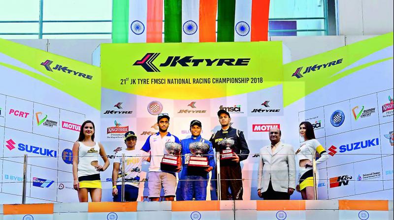 Champion Karthik Tharani (centre) is flanked by runner-up Nayan Chatterjee (second from left) and Ashwin Datta at the 21st edition of the JK Tyre FMSCI National Racing Championship at the Buddh International Circuit on Sunday.