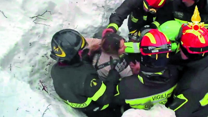 Firefighters rescue a woman. (Photo: AP)