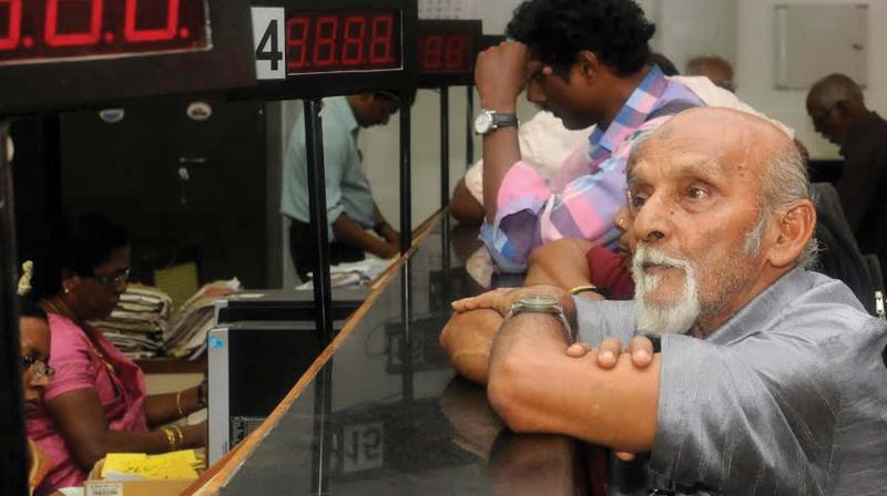 An elderly man waits at the treasury to draw pension in Thiruvananthapuram on Wednesday. (Photo: DC)