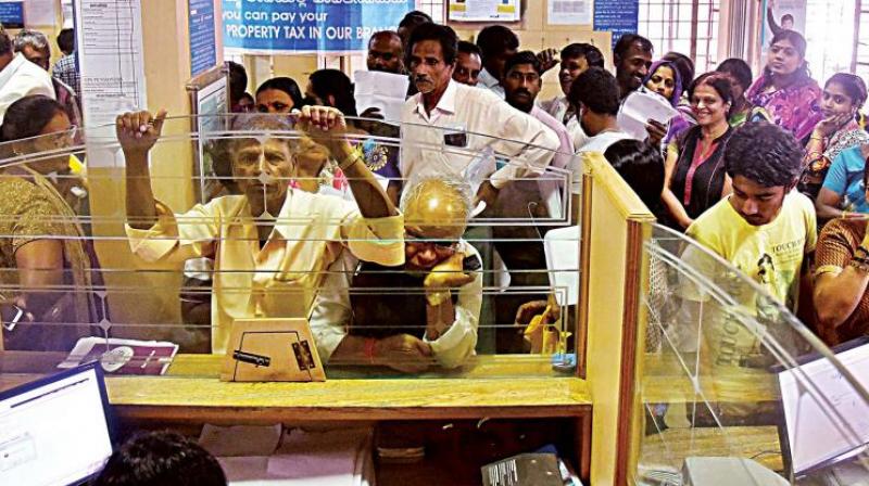 People wait for their turn to exchange demonitised currency notes at a bank in Bengaluru. (Photo: DC)