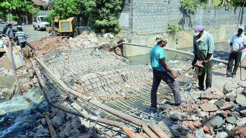 Cables of BSNL and other communication systems were damaged as contract workers do renovation works on a bridge near the Railway New Colony in Visakhapatnam on Tuesday. (Photo: DC)