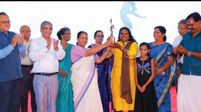 The first fisherwoman in India to secure the licence for deep-sea fishing Rekha Karthikeyan being presented the Sthree Ratna award for her outstanding achievement in the area of women empowerment instated by ESAF Small Finance Bank. State Womens Commission Chairperson M. C. Josephine presented the award at an event held in Thrissur on Saturday. (Photo: DC)