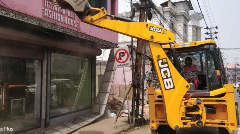 A shop being pulled down as part of a demolition drive in Muvattupuzha town on Saturday.